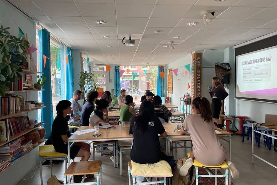 Participants following a presentation on Dutch working hours law during a Create Your Career session.
